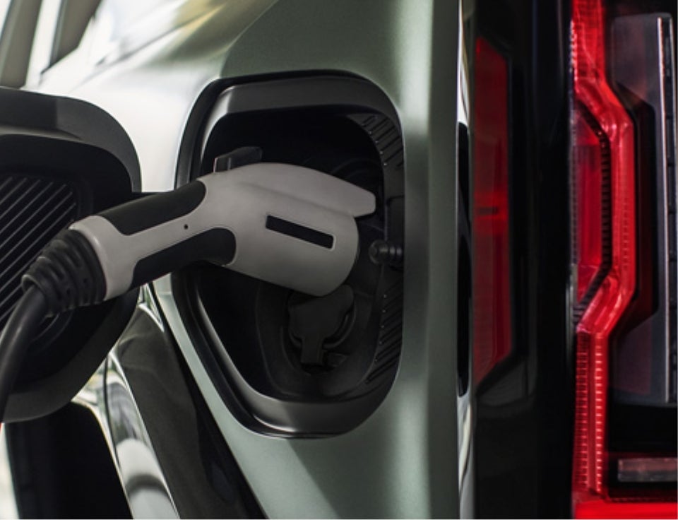 Close up of charging port with charger plugged in on a GMC Hummer EV SUV - Burke Motor Group GMC in Cape May Court House NJ