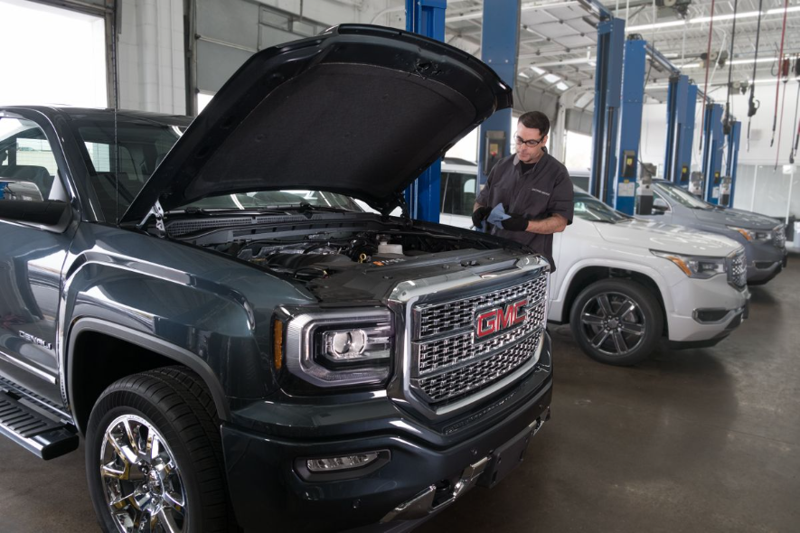 A man servicing GMC vehicle